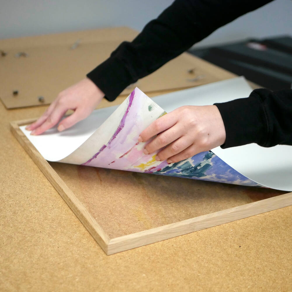 Printed artwork in process of being framed as part of Artelo’s fine-art finishing workflow.