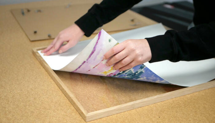 Printed artwork in process of being framed as part of Artelo’s fine-art finishing workflow.