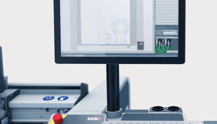 Zünd Systemtechnik monitor displaying packaging design software with a 3D box model and cutting parameters.